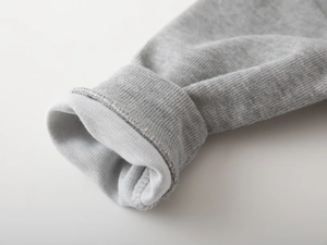 Close-up of ribbed cuffs on children's gray sweatshirt showing premium knit texture