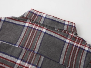 Detail of grey flannel plaid shirt collar and shoulder with refined stitching