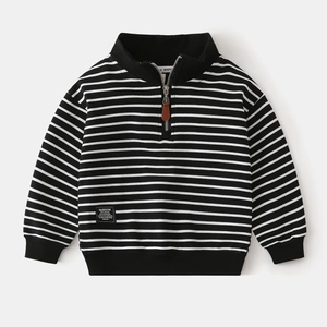 Close-up detail of children striped sweatshirt with premium brown leather zipper puller