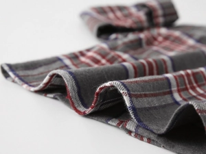 Macro detail of brushed cotton plaid fabric with red and blue checkered pattern