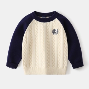 Detail of cable knit pattern and B embroidery on boy's navy and beige sweater