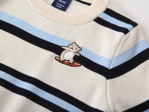 Close-up of baby striped sweater featuring a cute surfing bear embroidery and round neck