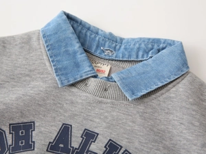 Detail of kids grey sweatshirt with denim collar, stitching, and neck label size info