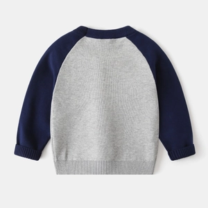 Detail of baby knit sweater with navy raglan sleeves and ribbed cuffs in gray