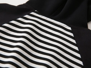 Detailed stitching of kids hooded sweatshirt with black and white striped sleeve patterns