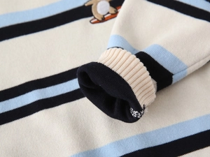 Detail of ribbed cuff and high-quality knit texture on a striped children sweater