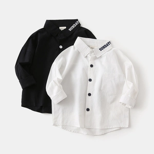 Detail of boys' shirts with SUNDAYS embroidery and cotton linen texture in black and white