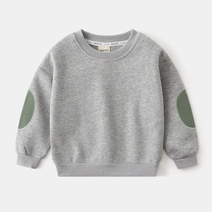Detail of light grey kids sweatshirt featuring contrast dark green oval elbow patches