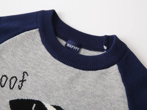 Detail of child's navy blue and grey knit sweater showing neckline texture and puppy pattern