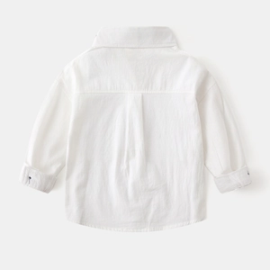 Detail view of boys' white cotton shirt back with comfortable box pleat and flat texture