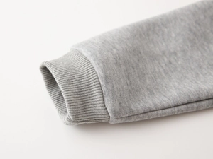 Close-up of elastic ribbed cuffs on a gray knit sweatshirt showing premium fabric texture