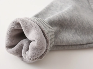 Detail of gray kids sweatshirt showing elastic ribbed cuffs and thick fleece lining