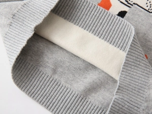 Detailed macro view of the ribbed cuff and knit texture on this gray children sweater