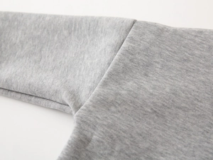 Close-up of high-quality stitching and gray cotton blend fabric on kids' sweatshirt
