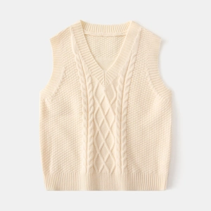 Detail of cream cable knit texture and V-neck ribbed hem on children's knitted vest