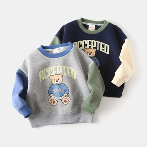 Detail of boys' patchwork sweatshirts with ACCEPTED letter and cartoon bear prints