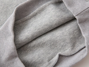 Macro detail of boys heather grey fleece sweatshirt with ribbed cuffs and soft interior