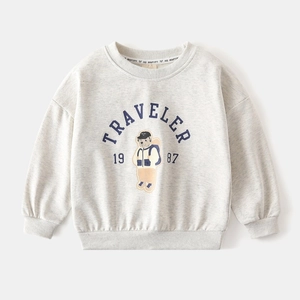 Close-up of the traveler bear illustration and ribbed crewneck on gray kids sweatshirt