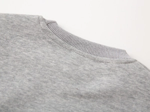 Detailed close-up of the ribbed crew neck and stitching on this grey cotton boys' sweatshirt