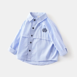 Detail of light blue striped boys' shirt with dark navy embroidered letter B crest