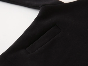Detailed close-up of a neat slanted pocket on a black fleece hoodie for boys