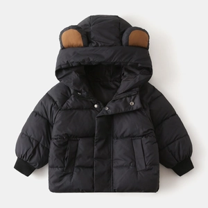 Detail of children's black quilted winter jacket featuring cute brown bear ear hood design