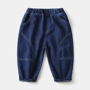 Detail of boys dark blue denim jeans featuring elastic waistband and decorative stitching
