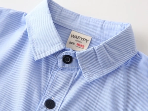 Close-up of blue striped cotton shirt featuring neat stitching and dark navy buttons