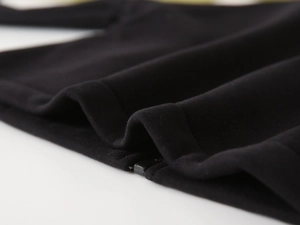 Close-up of durable black fleece fabric texture and smooth metal zipper on kids winter jacket