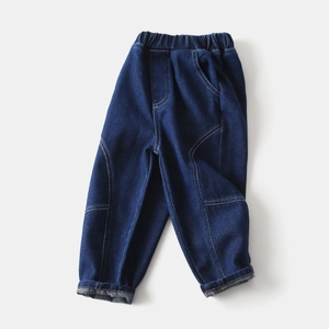 Detail view of boys indigo jeans with elastic waist and stylish stitching accents