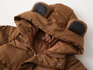 Detail of children's brown hooded winter jacket with cute bear ears and metallic snaps