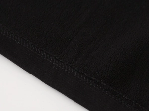 Detail of warm black fleece lining and durable double-stitched hem on kids jacket