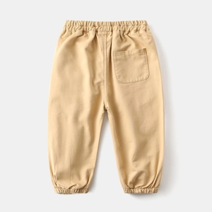 Detail of khaki cotton jogger pants featuring an elastic waistband and ribbed cuffs