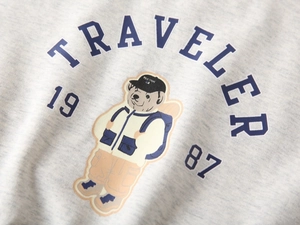 Detailed view of kids' gray sweatshirt featuring a retro teddy bear and traveler print