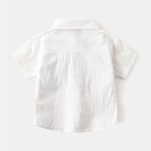 Back view of a white short-sleeved cotton shirt for boys with pleated detail
