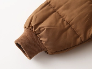 Detail view of the windproof ribbed elastic cuffs on the thick padded winter coat