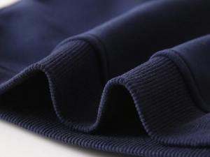 Detail of ribbed knit cuffs on kids navy blue sweatshirt with high elastic texture