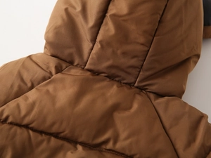 Detail of hood and neckline on kids quilted brown winter coat with soft padding