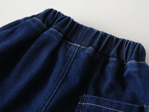Detail of boys denim jeans showing elastic waistband and fine stitching in indigo blue