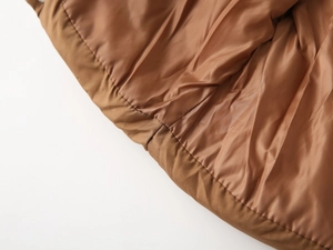 Close-up of high-quality stitching and smooth lining on a children winter padded jacket