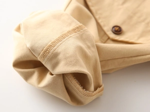 Close-up of khaki trousers with durable stitching detail and premium brown button