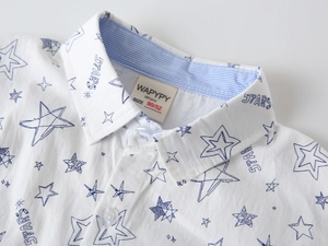 Detail of boys' white shirt collar with blue star print and striped inner lining detail