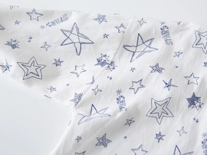 Close-up of white breathable fabric with blue star patterns and STARS typography print