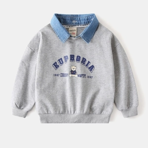 Détail du sweat gris pour enfant avec col en jean superposé et motif d'ours
