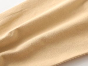 Macro shot of high-density khaki cotton twill fabric showing detailed weave texture