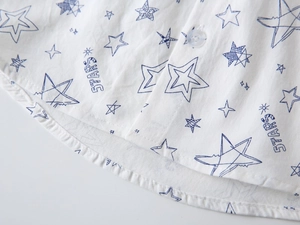 Macro detail of toddler star print shirt showing breathable fabric and resin buttons