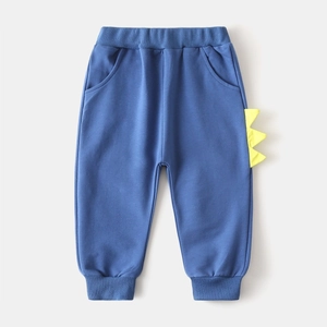 Vue détaillée du pantalon bleu marine pour enfants avec aileron de dinosaure et taille élastique