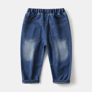 Detail of boys' mid-blue denim trousers featuring elastic waist and back pockets