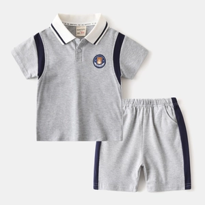 Detailed view of kids cotton polo set with bear embroidery and contrast navy panels