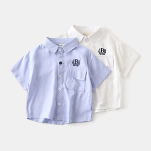 Detail of embroidered logo and chest pocket on cotton short-sleeved shirts for boys